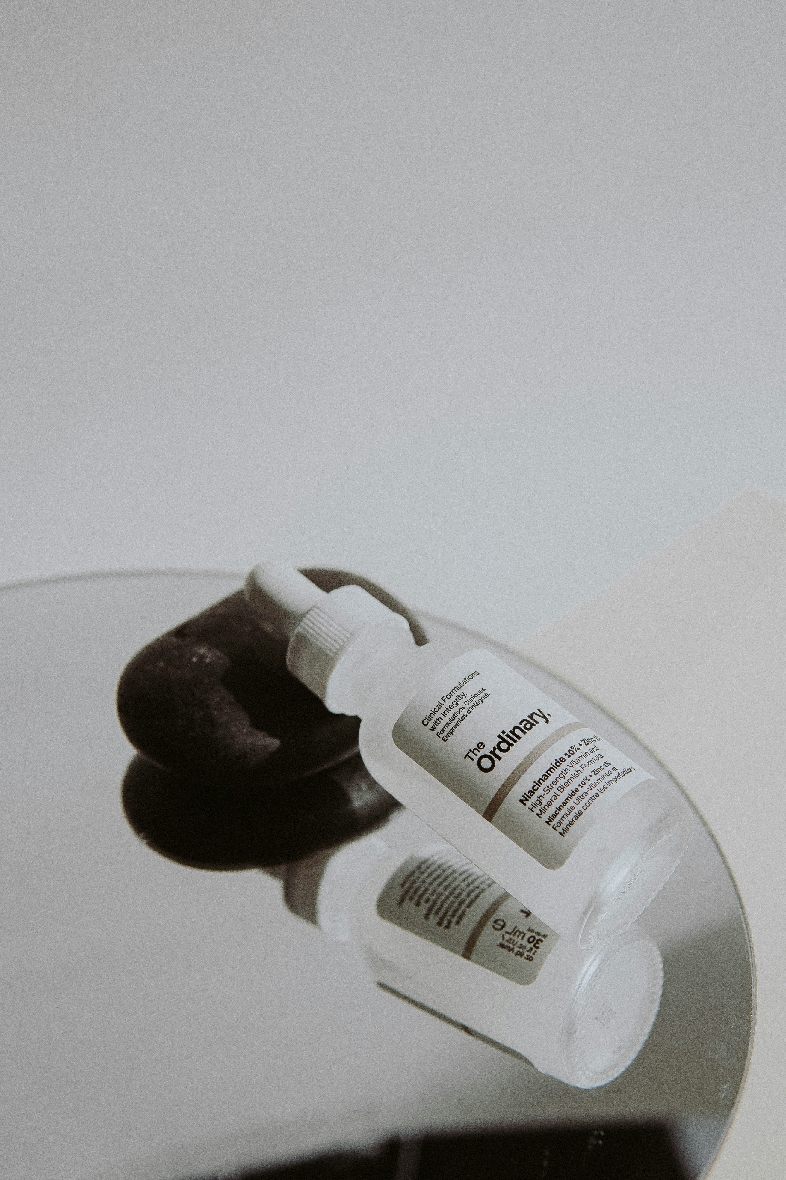 white plastic bottle on white table